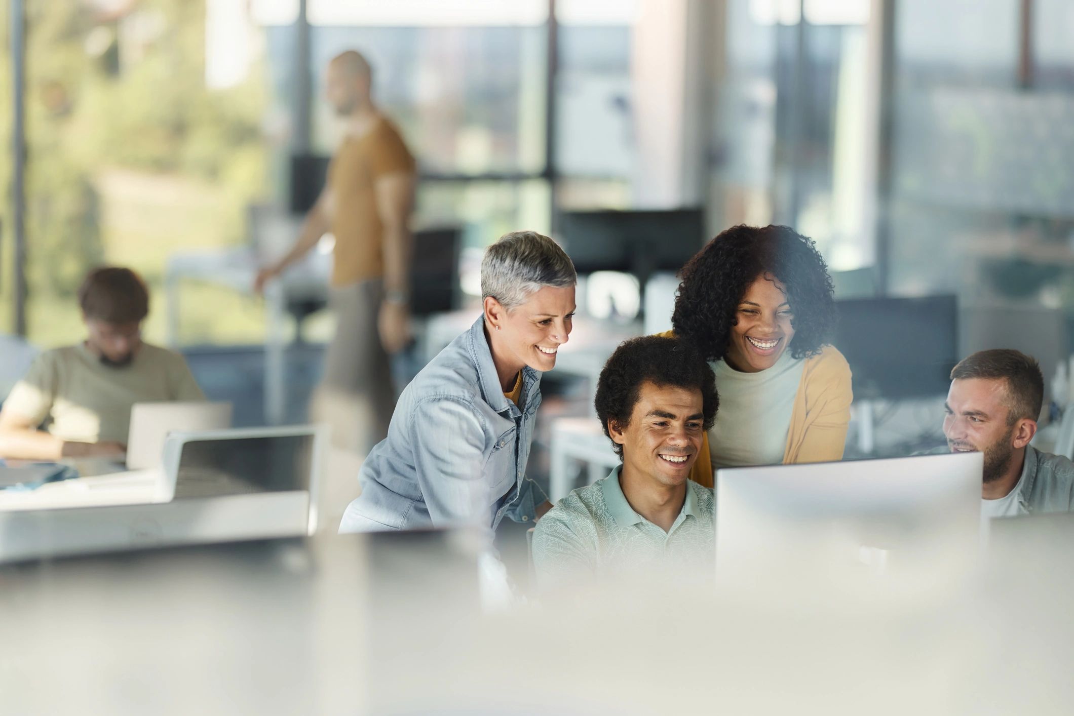 Team working together at desktop computers in an office